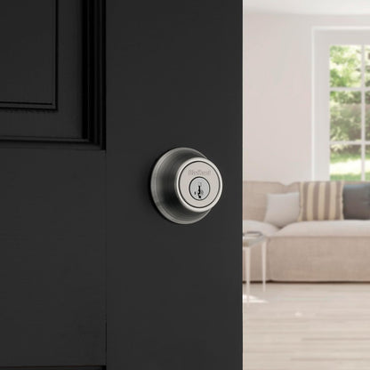 Kwikset 660 - Cerradura de cerrojo para puerta de entrada frontal redonda de níquel satinado, tornillo muerto de un solo cilindro, con protección Microban