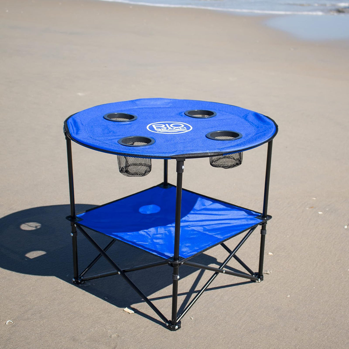 Rio Brands - Mesa de Playa Plegable portátil de Tela Ligera Redonda de 28 Pulgadas con portavasos, Color Azul